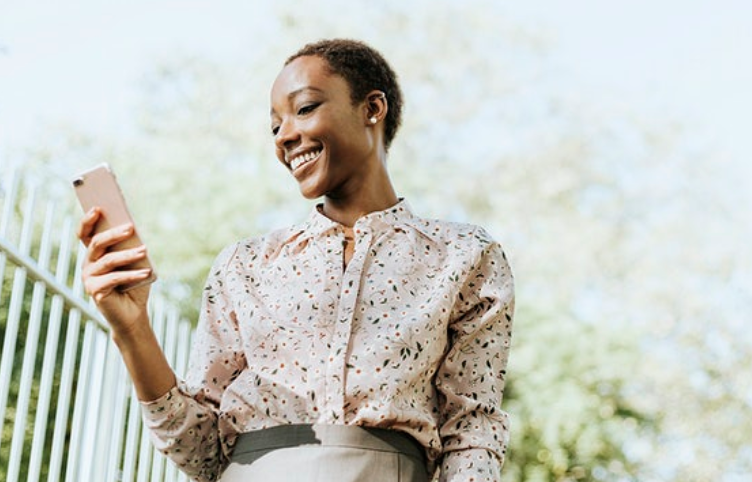 black woman holding a phone